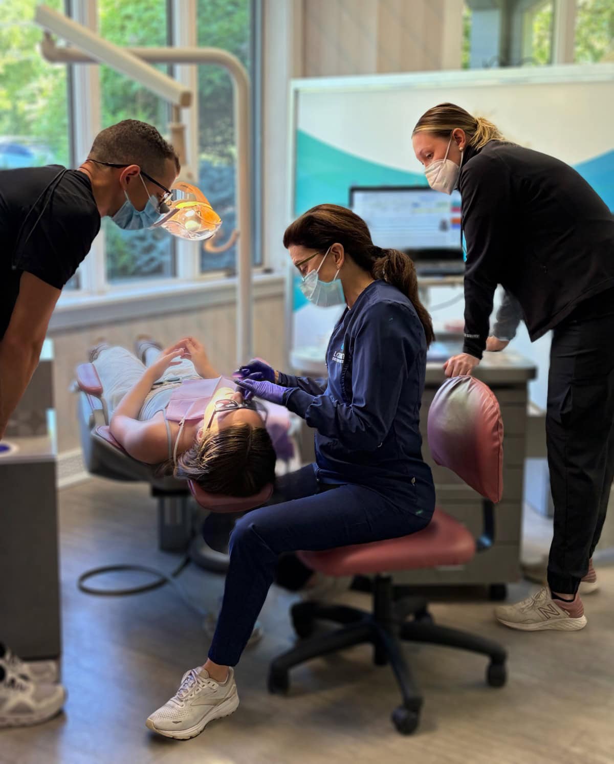 Orthodontist examining a young visitor's smile in the office