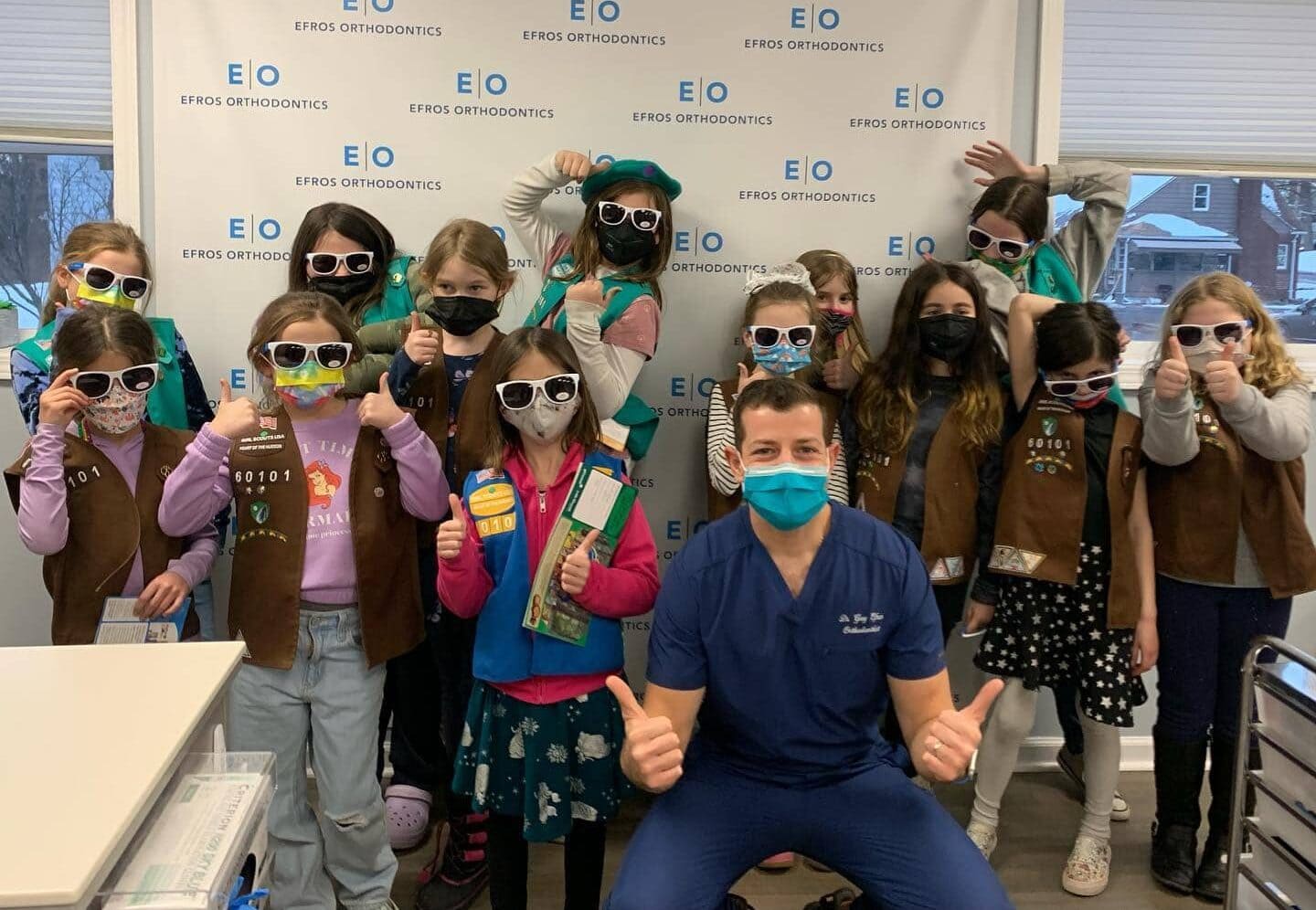 Dr. Greg Efros with a local Girl Scout troop at Efros Orthodontics